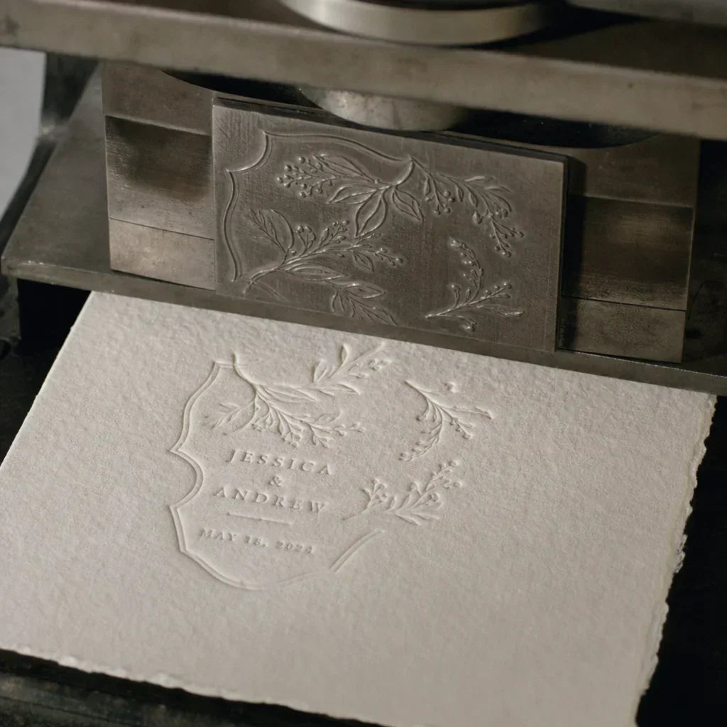 Close-up of deep letterpress embossing on 100% cotton paper for a luxury wedding invitation.